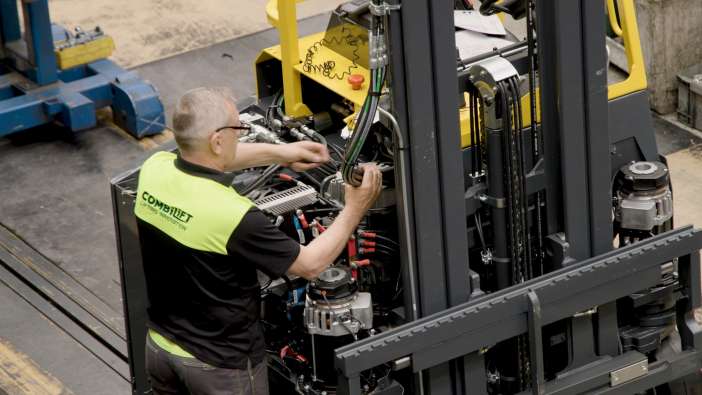 Combilift factory worker wiring forklift