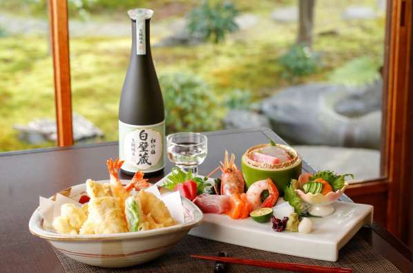 photo of sushi and sake set up on a table from foodex group