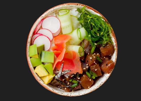 photo looking down on a bright colored poke bowl with fish and vegetables