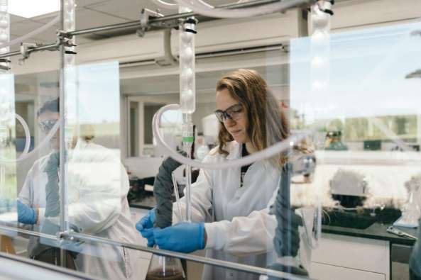 photo of a lab worker studying a material in a lab