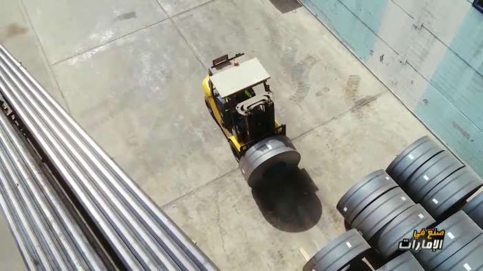 overhead shot of a forklift carrying and organizing barrels