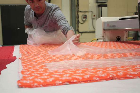 photo of a textile worker working with textiles