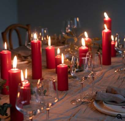 candles burning dining table set glassware plates