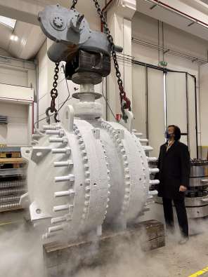 large white industrial manufacturing part lifted with a crane