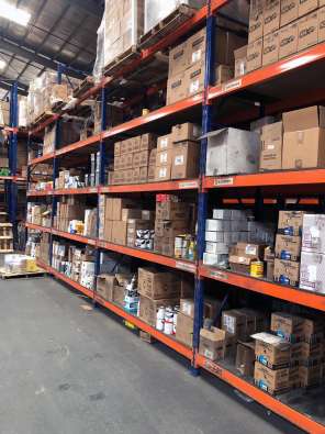 photo from the inside of a warehouse with multiple boxes on shelves
