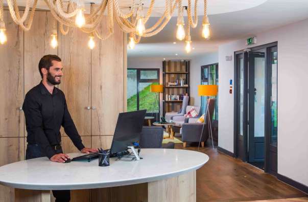 photo of a front desk worker at a starboard hotel in england