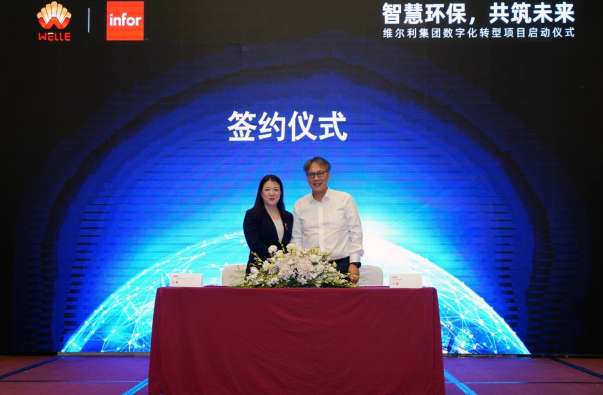 Photo of two executives posing at the welle environmental group and infor signing ceremony