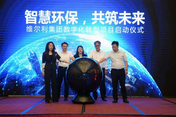 photos of executives touching a large globe at the welle and infor signing ceremony