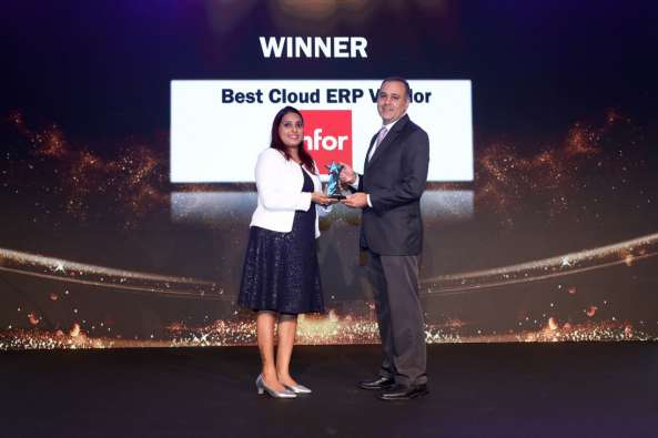 photo of infor vp of global professional services salem machaka accepting best cloud erp vendor award