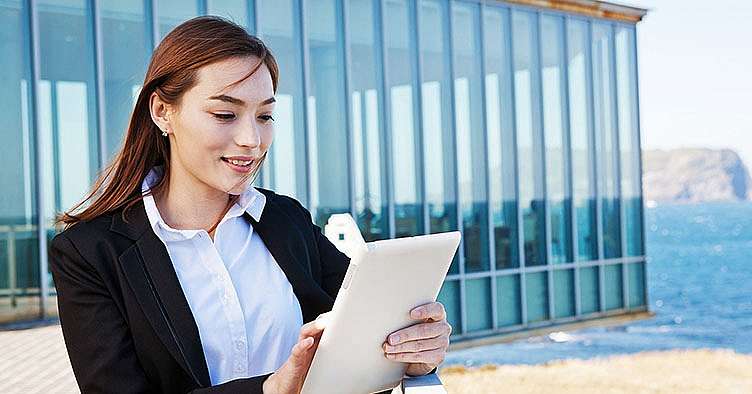 stock photo of a business woman looking at an ipad