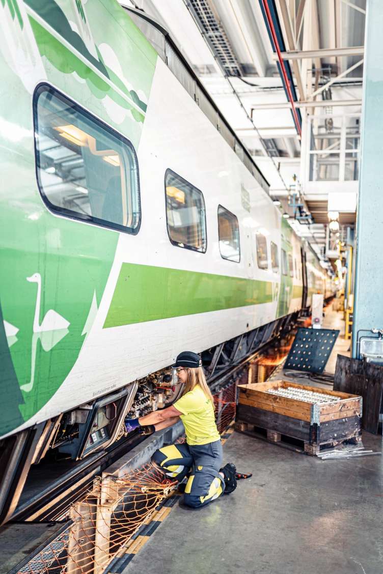 photo of a worker working on a public transit rail car