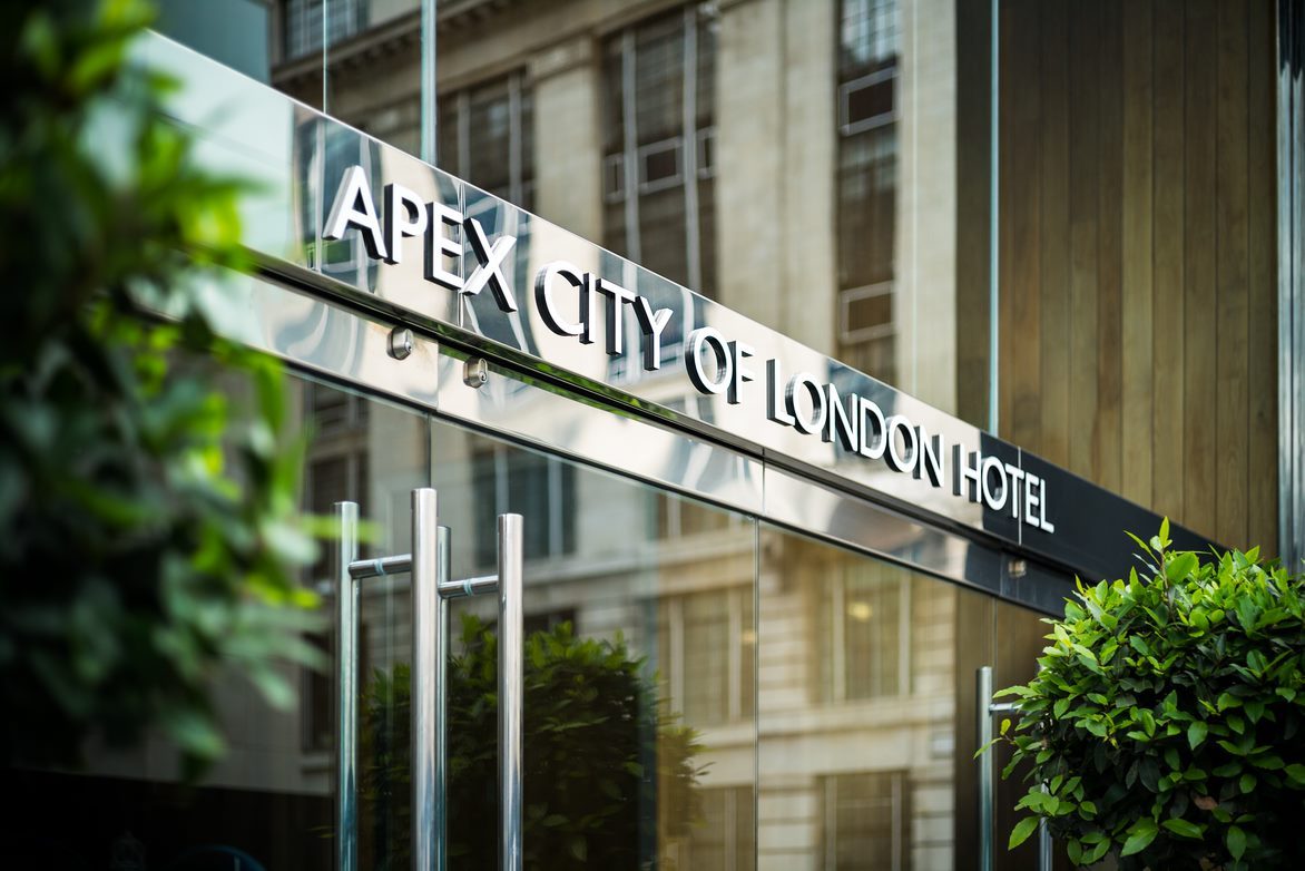 sign on the door that reads apex city of london hotel
