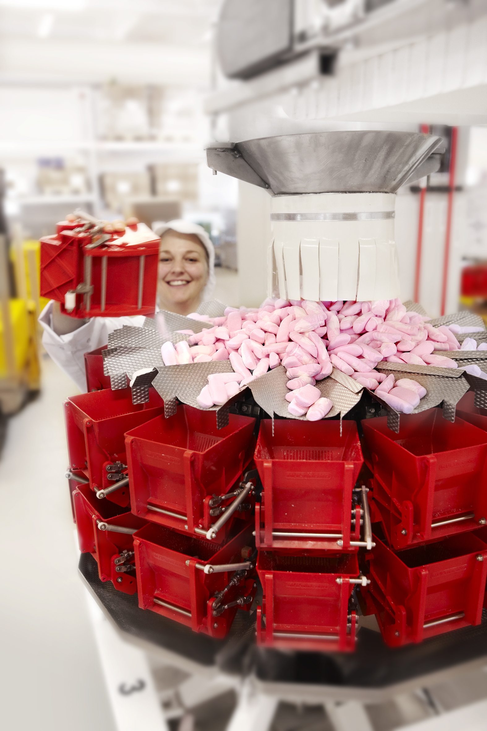 photo of a food production working smiling while making candy
