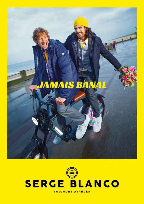 yellow serge blanco ad with a photo of 2 guys riding an electric bike