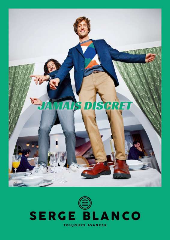 green serge blanco poster with two well dressed guys on top of a table