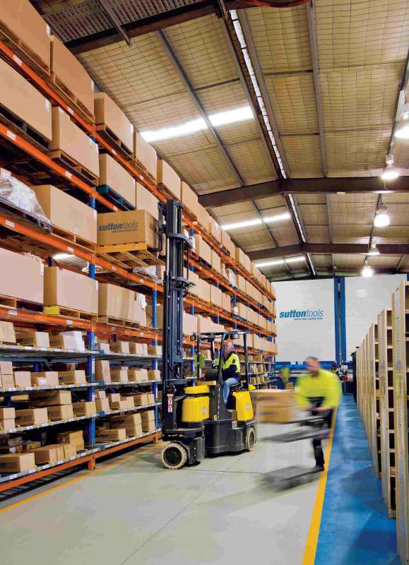 photo inside of the sutton tools warehouse with a forklift carrying items
