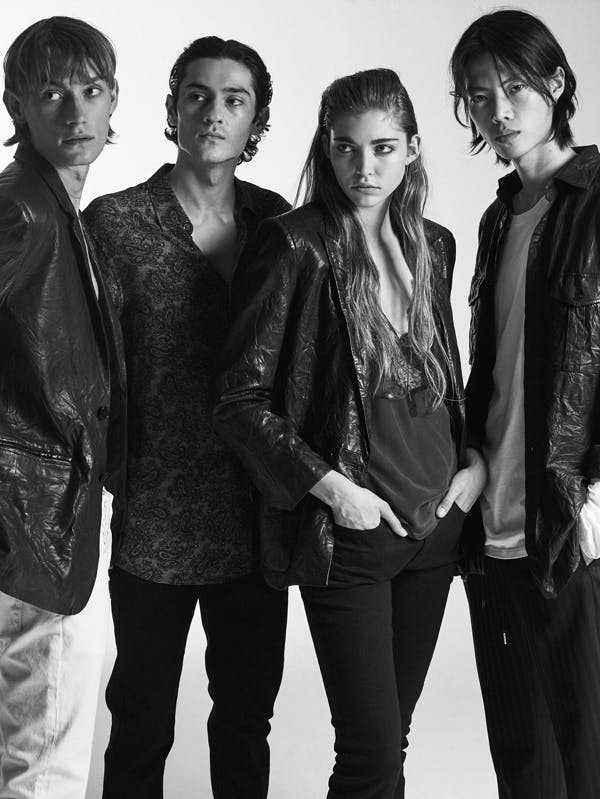 4 models pose in black and white promotional fashion photo