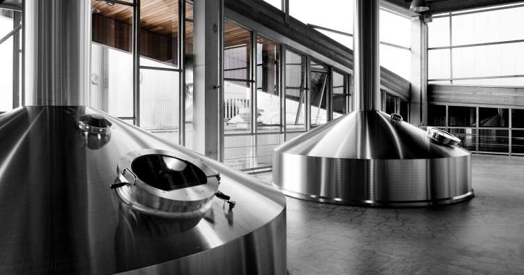 photo of brand new silver brewing equipment at a production facility