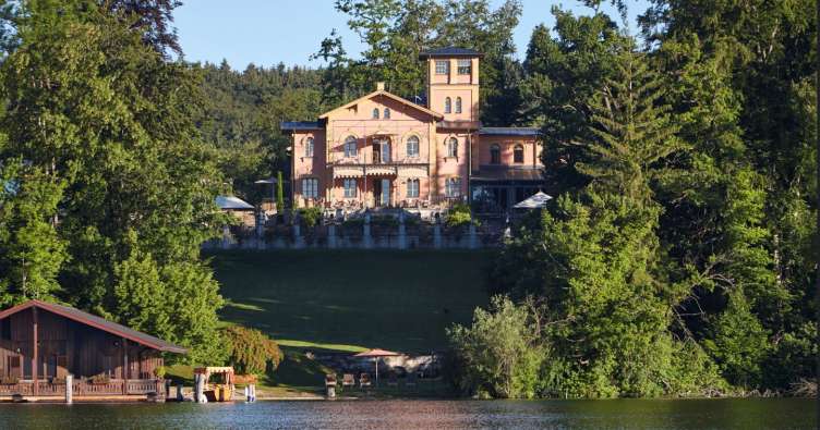 photo of a large villa across the water