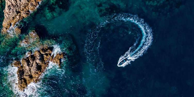 aerial shot of a speetboat moving in the ocean