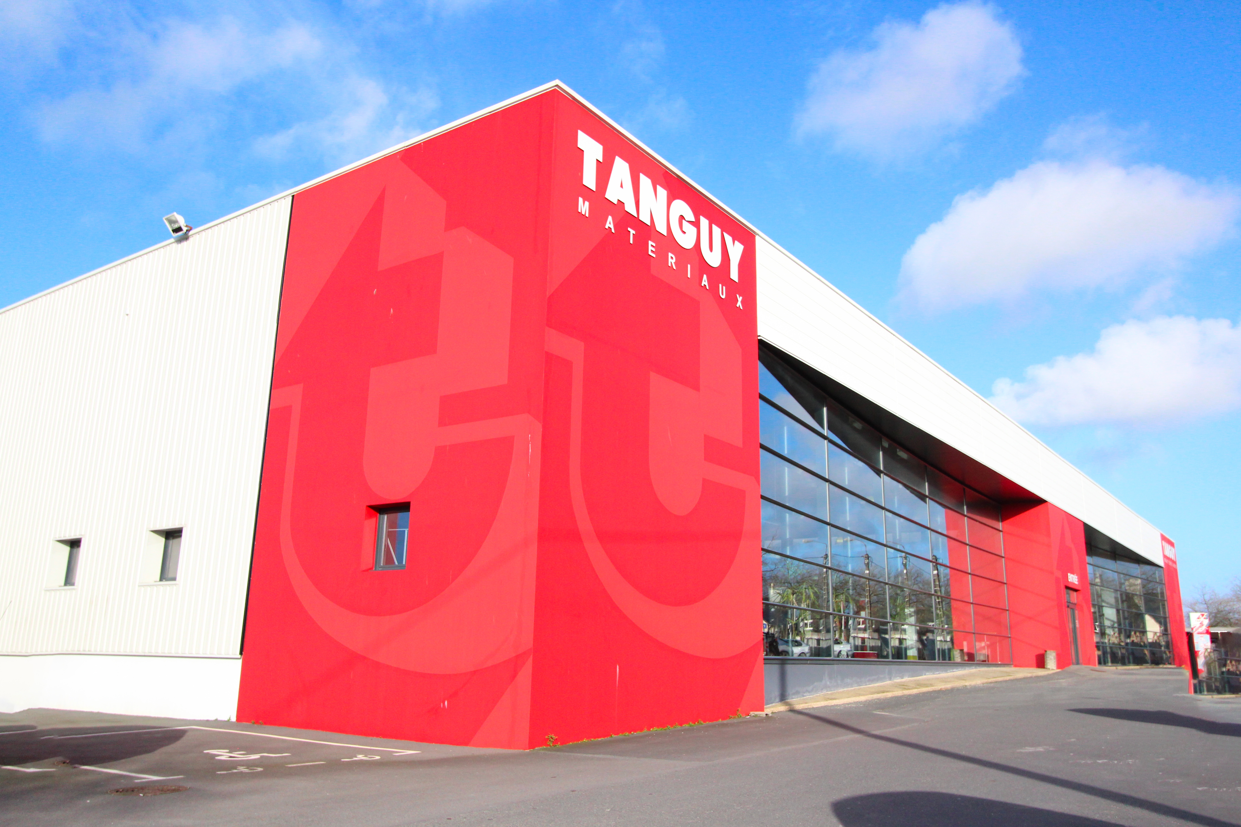 photo of the exterior of a white and red tanguy building