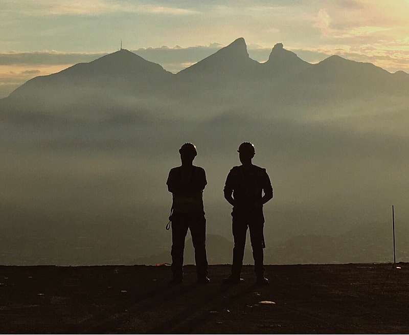 Two people looking at the sunset in industrial manufacturing